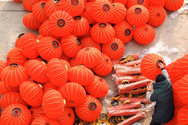 Một công nhân làm đèn lồng đỏ tại xưởng ở Lianyungang, tỉnh Giang Tô, Trung Quốc Một công nhân làm đèn lồng đỏ tại xưởng ở Lianyungang, tỉnh Giang Tô, Trung Quốc
