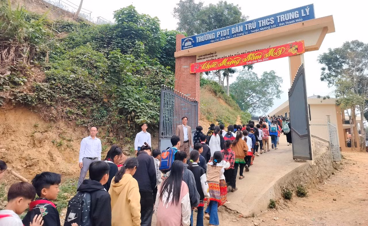 Ban Giám hiệu Trường PTDTBT-THCS Trung Lý đứng ở cổng trường chào đón học sinh trở lại trường sau kỳ nghỉ Tết. Ảnh: DT.
