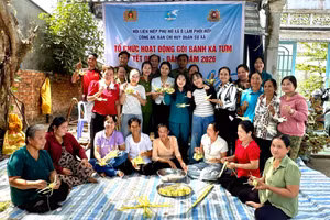 Hội viên phụ nữ, cùng cán bộ, chiến sĩ Công an và lực lượng dân quân tham gia gói, làm bánh Ka Tum.