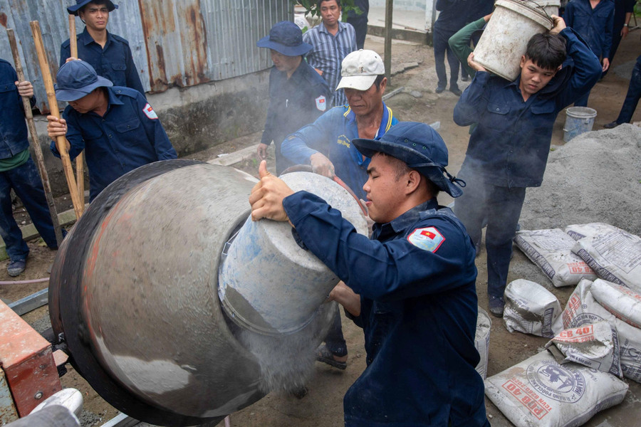 Đội K93 hỗ trợ người dân đổ bê tông đường nông thôn. Ảnh: Hữu Đặng. 1000056499.jpg