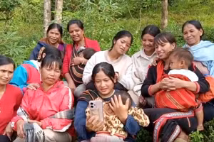 Người dân tranh thủ thời gian trên rẫy xem bài học trên kênh "Bình dân học vụ".