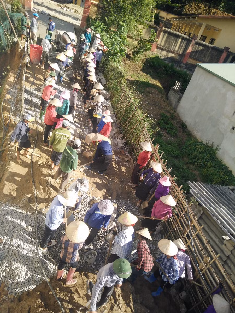Bà con bản Che Phai 1 đồng lòng tham gia làm đường nhân ái số 10 lên điểm trường mầm non. Ảnh: Nguyễn Dũng