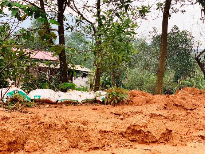 Người dân dùng bao cát chắn đất đá trôi vào vườn. Người dân dùng bao cát chắn đất đá trôi vào vườn.