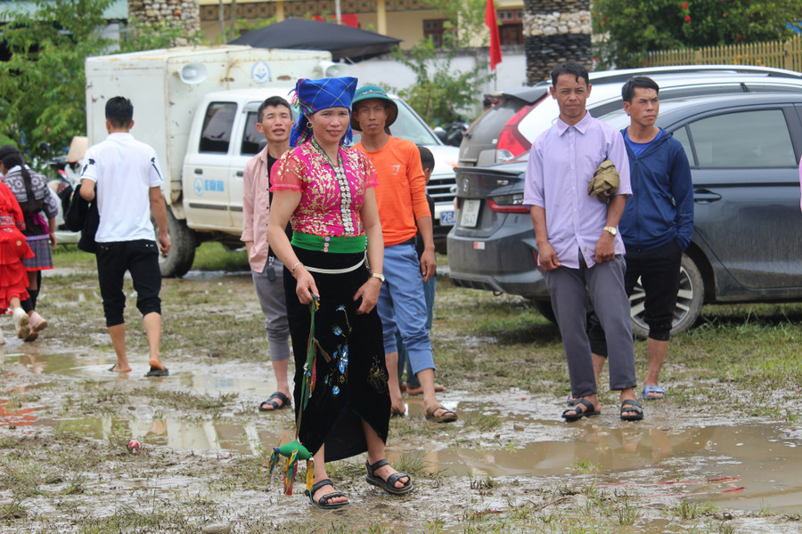 Bà con tham gia trò chơi ném còn trong thời tiết mưa phùn.
