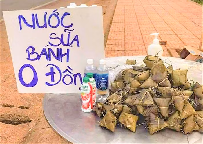 Dọc quốc lộ 14 (thuộc địa phận tỉnh Đắk Nông) còn có các điểm tặng bánh chưng, bắp luộc, nước lọc, sữa hộp… với giá 0 đồng cho người về từ các tỉnh phía nam. Bánh ú, nước lọc, sữa tươi... phục vụ người đi đường. Nguồn: TPO.