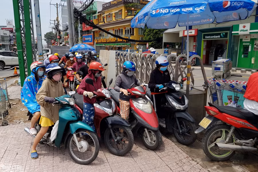 Người dân chen nhau vào bãi gửi xe máy siêu thị lớn ở ngã tư Thủ Đức, nguồn: Dân Trí.