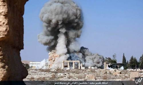 This undated photo released Tuesday, Aug. 25, 2015 on a social media site used by Islamic State militants, which has been verified and is consistent with other AP reporting, shows smoke from the detonation of the 2,000-year-old temple of Baalshamin in Syria
