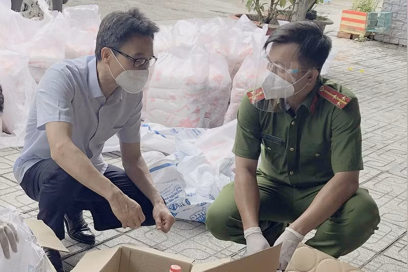 Phó Thủ tướng Vũ Đức Đam trao đổi với Thượng uý Hồ Lê Mạnh Hùng, công tác tại Công an phường Tân Chánh Hiệp về việc nắm thông tin của 100% người dân trên địa bàn để hỗ trợ kịp thời. Ảnh: PLO.