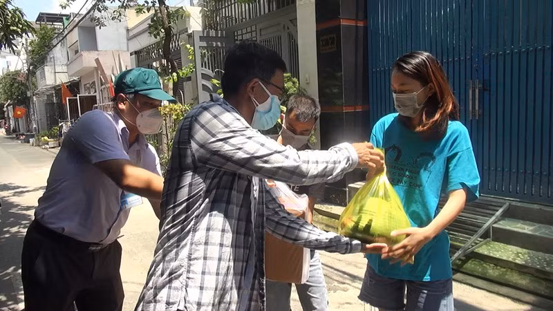 Chính quyền, chủ nhà trọ cùng giúp dân an tâm ở lại TP Hồ Chí Minh. Trong ảnh: Ông Nguyễn Văn Đức, Phó Chủ tịch UBND phường Bình Hưng Hòa B, quận Bình Tân đến chỗ trọ, gửi tặng quà, động viên hai vợ chồng anh Luận - chị Quỳnh. Nguồn: PLO.