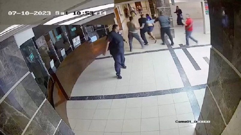 Một người đàn ông mặc quần short, áo sơ mi xanh nhạt được cho là bị 5 người đàn ông Hamas kéo qua nơi tiền sảnh của bệnh viện, ngày 7/10/2023