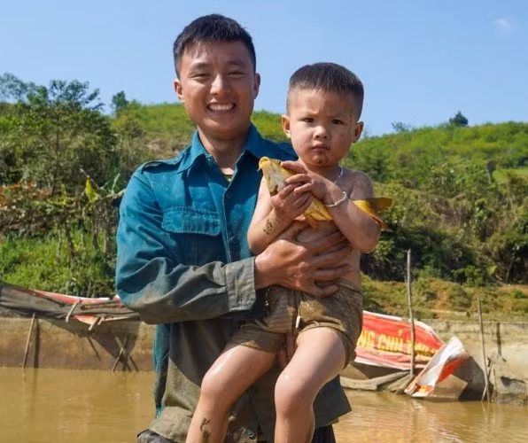 Hai bố con một nông dân vui tươi bên thành quả thu được.