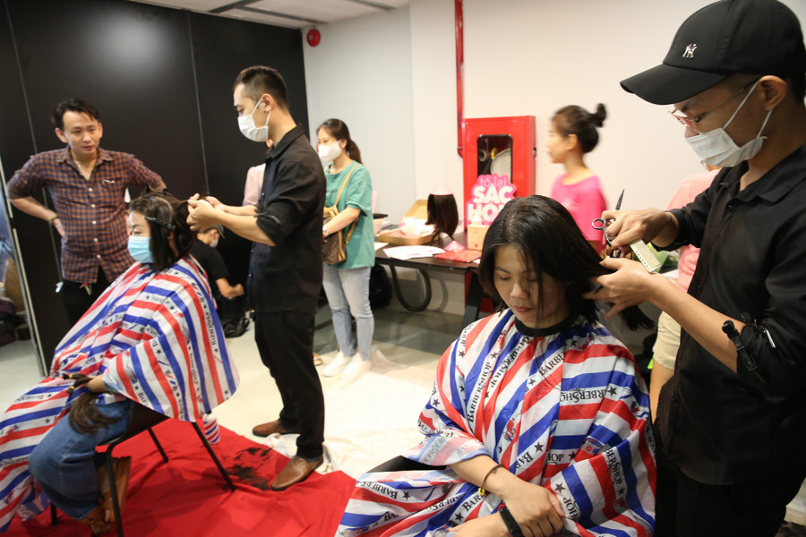 Bạn trẻ tham gia hoạt động cắt tóc quyên góp bệnh nhân ung thư tại Phiên chợ Lại đây sống xanh năm 2022
