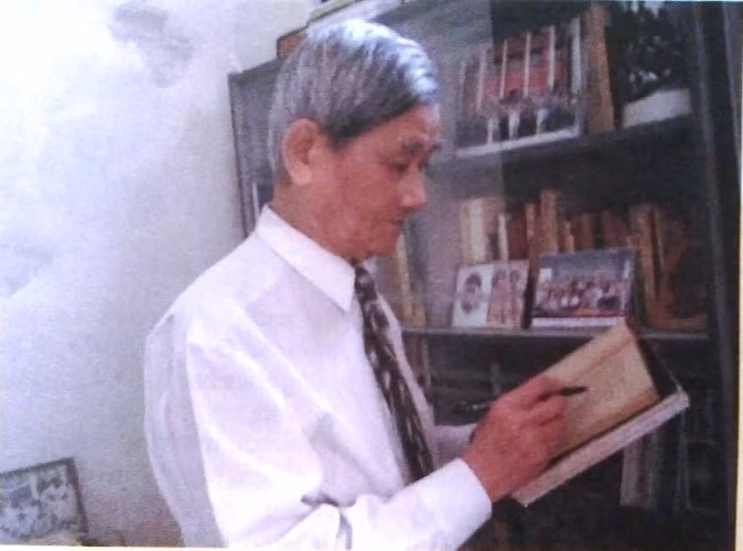 Nhà thơ Nguyễn Xuân Sanh ở tuổi 87 bên giá sách tư gia.