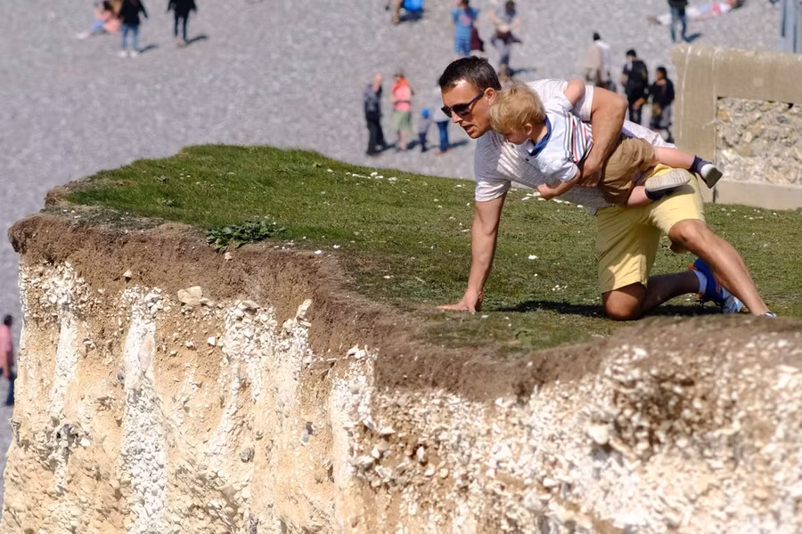 Hình ảnh người đàn ông bất chấp nguy hiểm bế con trai nhỏ.