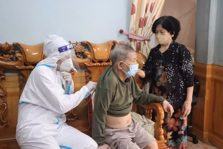 Trước tiêm, ông Phạm Xuân Thành, phường Mường Thanh được cán bộ y tế khám sàng lọc, tư vấn về vắc-xin.