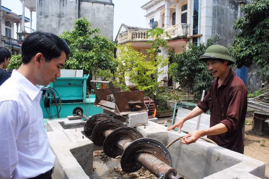 Ông Ngô Thái Nguyên (thứ hai bìa phải) giới thiệu quy trình hoạt động của máy xử lý rác.