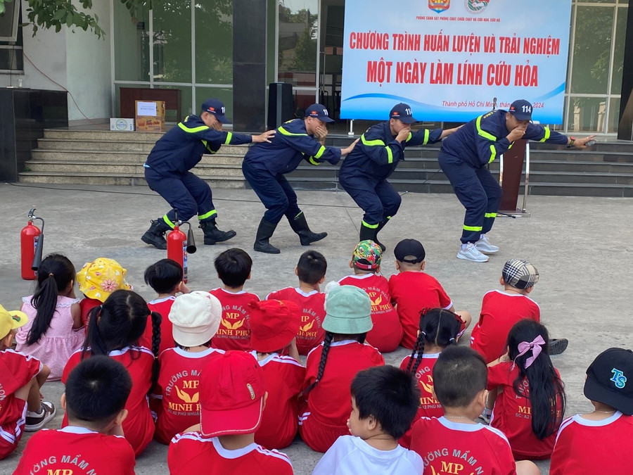 Đại úy Phạm Văn Duy Việt (đầu tiên) cùng các chiến sĩ Phòng PC07 hướng dẫn các bé kỹ năng di chuyển an toàn để rời khỏi nơi xảy ra sự cố cháy nổ