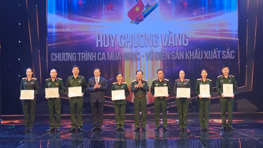 Đại tá, nhạc sĩ, NSƯT Nguyễn Tuấn Anh (thứ 3 từ trái sang) nhận Huy chương Vàng từ Ban tổ chức Hội diễn nghệ thuật chuyên nghiệp về đề tài quốc phòng toàn dân năm 2023. Ảnh: NVCC