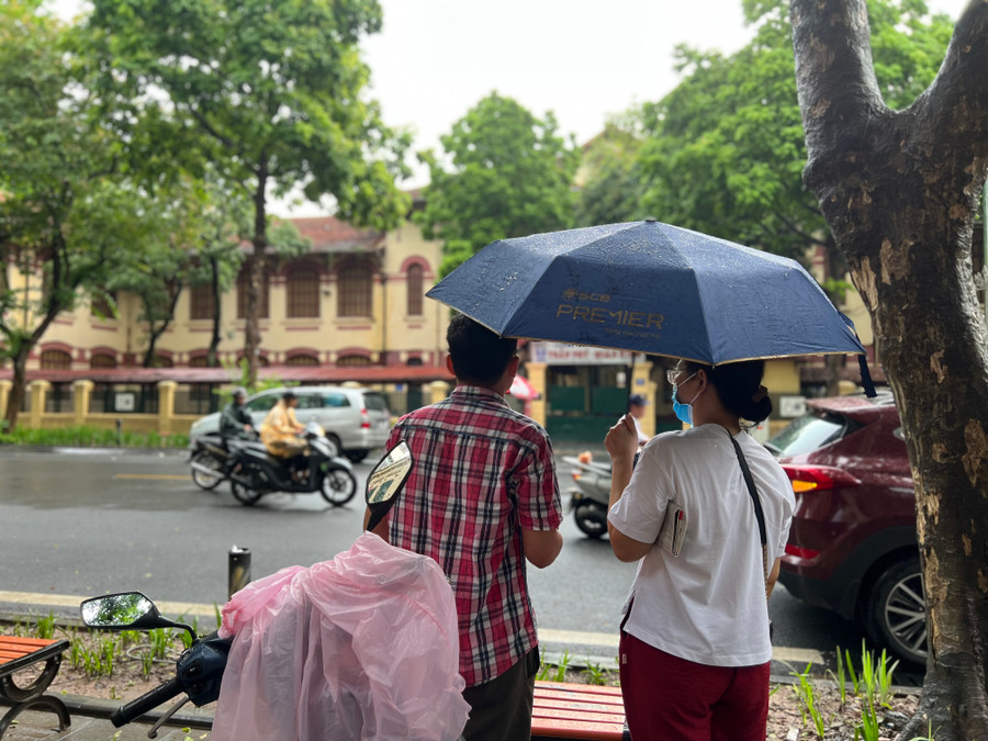 Phụ huynh đội mưa chờ con vào thi.