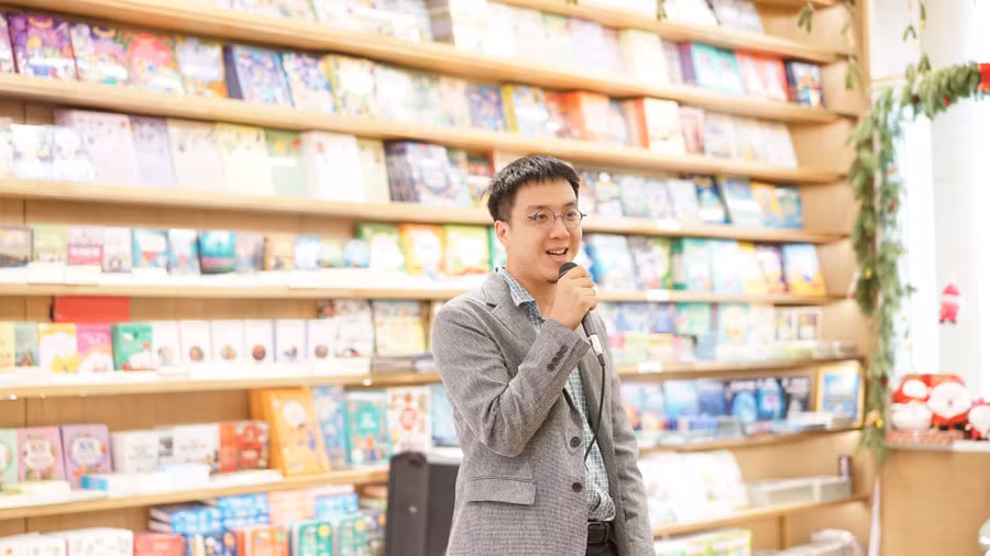 Anh Nguyễn Xuân Minh trò chuyện tại triển lãm 'Sự trở lại của chim rẽ mỏ thìa'. Ảnh: Nhã Nam.