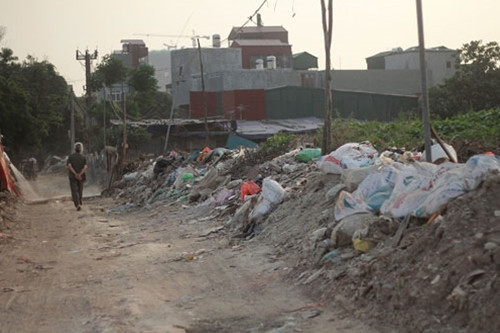 Những đống rác hai ven đường chất cao sừng sững, bốc mùi hôi thối.