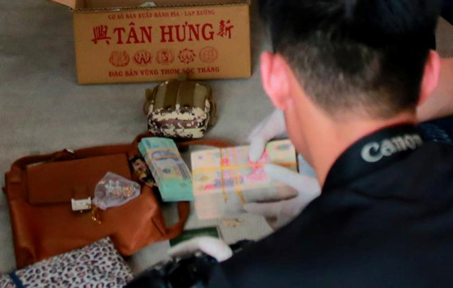 2 xấp tiền được tìm thấy trên ôtô chở 4 nghi can. Ảnh: Văn Minh. Nhieu tien mat tren oto cho 4 nu nghi can vu 2 thi the trong be tong hinh anh 1