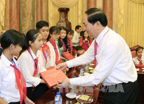 Chủ tịch nước Trần Đại Quang tặng quà các em học sinh nghèo hiếu học, học giỏi, trẻ em có hoàn cảnh đặc biệt, khó khăn. Ảnh: TTXVN