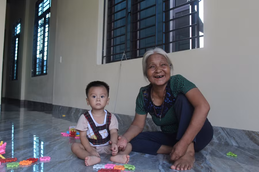 Bà Hoạt chăm sóc các cháu trong căn nhà mới của mình.