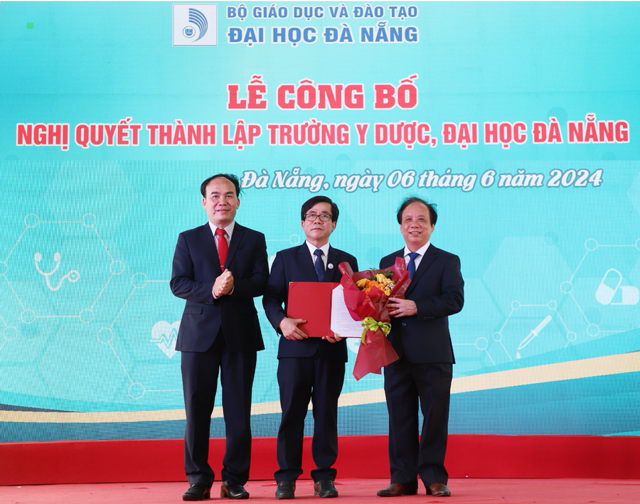 PGS.TS Nguyễn Ngọc Vũ, Giám đốc ĐH Đà Nẵng (bìa phải) và TS.Phan Minh Đức Bí thư Đảng ủy, Chủ tịch Hội đồng ĐH Đà Nẵng (bìa trái) trao Nghị quyết thành lập Trường Y Dược, ĐH Đà Nẵng.