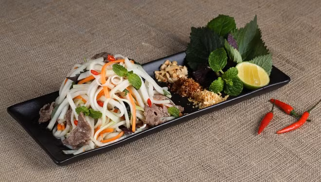 Nộm cũng là một món ăn quen thuộc trong mâm cỗ ngày xuân. Khi đã quá nhiều món chiên xào được bày ra thì nộm chính là một món chống ngán vô cùng hiệu quả khiến người ăn thêm ngon miệng. Cách làm: su hào, cà rốt thái sợi hơi to hơn bình thường để khi trộn không bị quá ỉu. Rau tía tô và một số loại rau gia vị thái rối trộn cùng. Hành tỏi băm nhỏ thơm phi lên, lạc rang trộn cùng nộm. Trộn tất cả cùng nước mắm, giấm, tỏi ớt. Thịt trâu trộn với dầu ăn, đem xào và trộn với nộm sau cùng. Vua đầu bếp khoe xôi hạt dẻ, nộm thịt trâu dịp Tết Ất Mùi