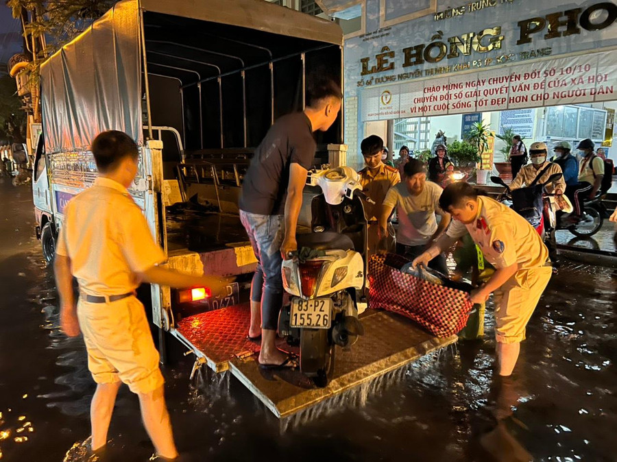 Lực lượng chức năng hỗ trợ người dân, xe máy qua khỏi khu vực ngập nước. Lực lượng chức năng hỗ trợ người dân, xe máy qua khỏi khu vực ngập nước.