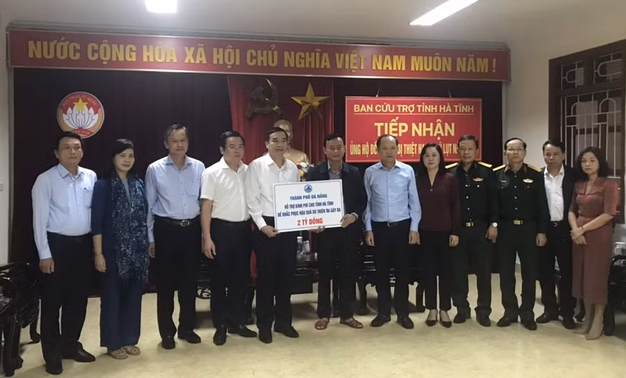 Ông Lê Trung Chinh (thứ 5, từ trái sang) – Phó Chủ tịch Thường trực UBND TP Đà Nẵng trao 2 tỷ đồng tiền hỗ trợ cho tỉnh Hà Tĩnh, để khắc phục thiệt hại do bão lũ gây ra.