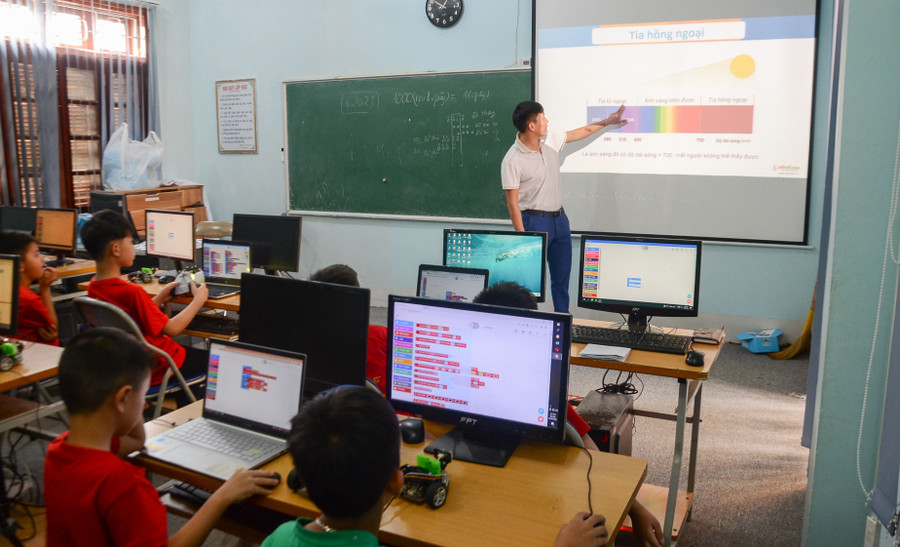 Giáo viên hướng dẫn học sinh giao tiếp với robot bằng ngôn ngữ qua các bài tập.