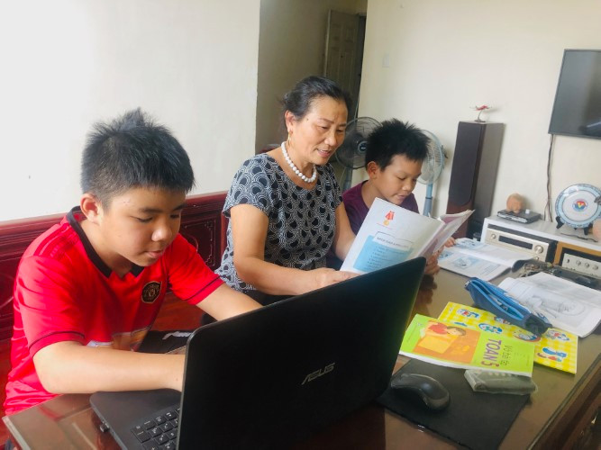 Phụ huynh hướng dẫn học sinh ôn tập tại nhà trong đợt tạm nghỉ học do dịch bệnh Covid-19. Ảnh minh họa: Phan Nga