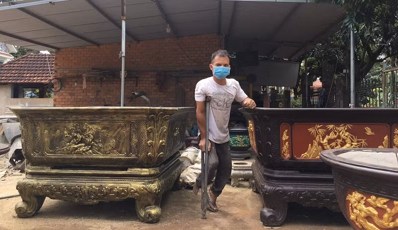 Anh Y Phăng Mlô bên chậu cảnh tự sản xuất để kinh doanh. Ảnh: NVCC