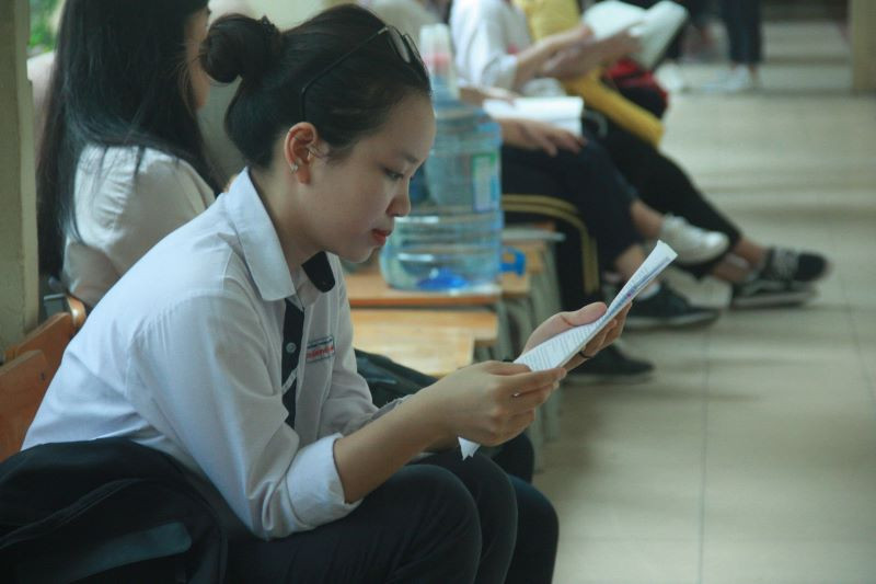 Chờ đợi trước khi được gọi vào phòng thi, thí sinh này tranh thủ đọc lại bài vở