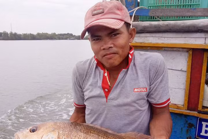 Anh Cường ôm con cá 7 kg, nghi là sủ vàng