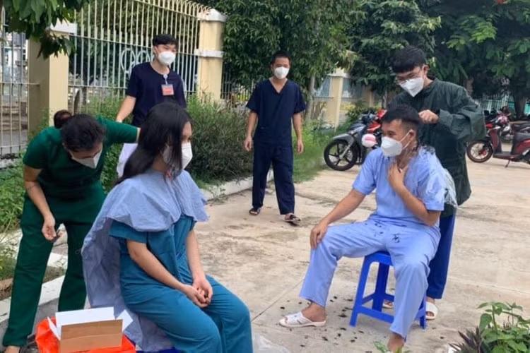 Thầy Hồ Văn Đây (Trường THCS Tùng Thiện Vương) tham gia cắt tóc cho các y bác sĩ và tình nguyện viên tại bệnh viện dã chiến.