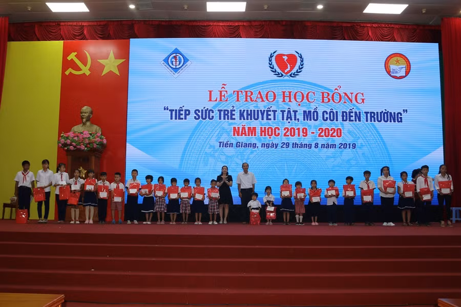 Học sinh nhận học bổng và quà tại buổi lễ.