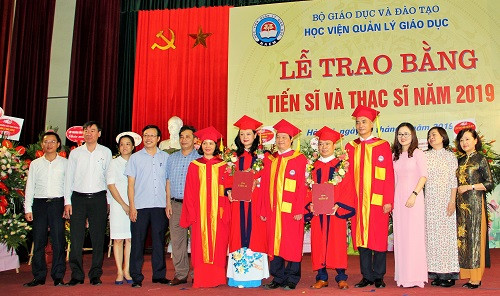2 tân tiến sĩ chụp ảnh cùng Ban Giám đốc và các lãnh đạo phòng/ban, giảng viên Học viện