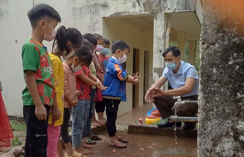Giáo viên Trường PTDTNT Tiểu học Phìn Hồ (huyện Nậm Pồ) hướng dẫn học sinh rửa tay bằng xà phòng.