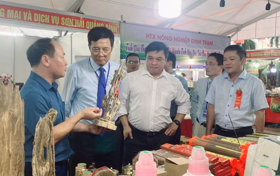 Phó Chủ tịch UBND tỉnh Quảng Bình Phan Phong Phú (ngoài cùng bên phải) và ông Phạm Quang Hải (mặc cà vạt), Giám đốc Sở Công Thương tỉnh Quảng Bình cùng các đại biểu tham quan Hội chợ.