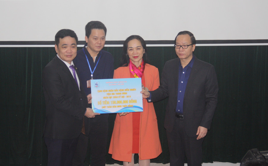 Thầy Đoàn Công Thạo, Hiệu trưởng Trường THCS Giảng Võ trao tượng trưng hỗ trợ 150 triệu đồng cho các bệnh nhi. Ông Trần Minh Điển - Phó Giám đốc Bệnh viện Nhi Trung ương thay mặt các bệnh nhân lên nhận hỗ trợ.