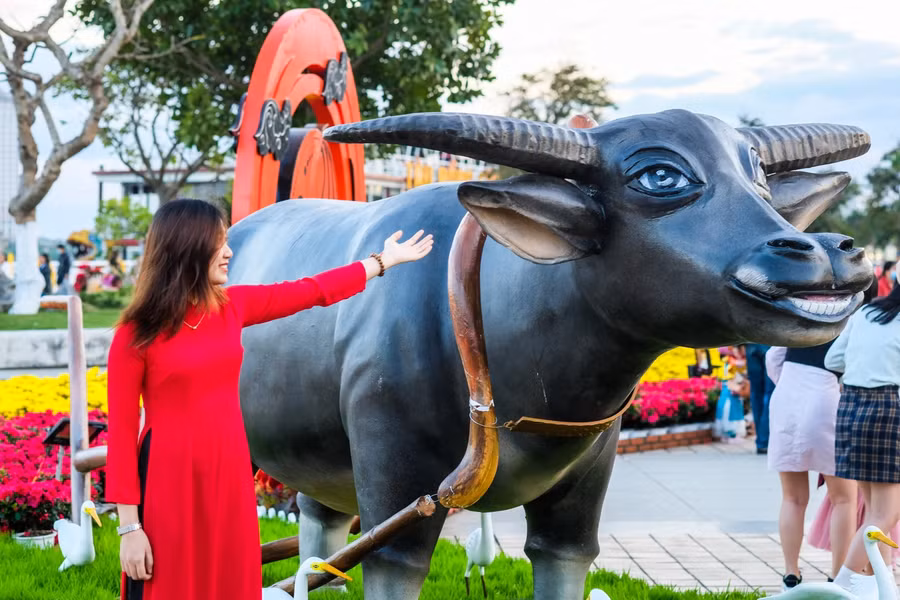 Người dân và du khách thích thú bên tiểu cảnh con trâu ở đường hoa.