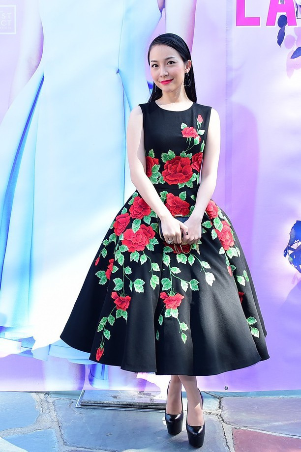 Cùng chọn trang phục của NTK Đỗ Mạnh Cường khi đến dự show xuân hè của anh, Linh Nga tự tin khoe dáng trong bộ đầm đen, họa tiết hoa hồng thêu tinh xảo trên thân váy. Gam màu tôn làn da trắng hồng của bà mẹ một con. Thủy Top, Đông Nhi dẫn đầu nhóm sao mặc đẹp trong tuần