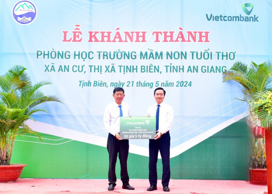 Đại diện Vietcombank trao bảng tượng trưng kinh phí hỗ trợ xây dựng Trường Mầm non Tuổi Thơ cho UBND TX. Tịnh Biên. (Ảnh: TT) Đại diện Vietcombank trao bảng tượng trưng kinh phí hỗ trợ xây dựng Trường Mầm non Tuổi Thơ cho UBND TX. Tịnh Biên. (Ảnh: TT)