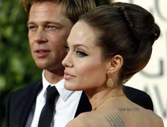 Brad Pitt và Angelina Jolie cho thấy những quan điểm khác nhau về chuyện hình xăm của con - Ảnh: Reuters