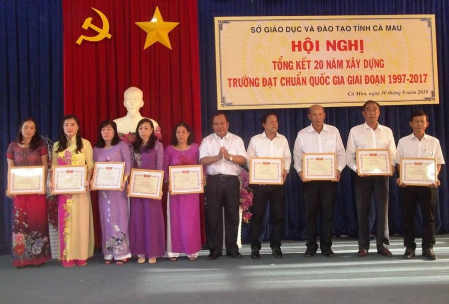 Giám đốc Sở GD&ĐT Cà Mau Nguyễn Minh Luân trao giấy khen cho các tập thể và cá nhân hoàn thành tốt trong công tác xây dựng trường chuẩn QG