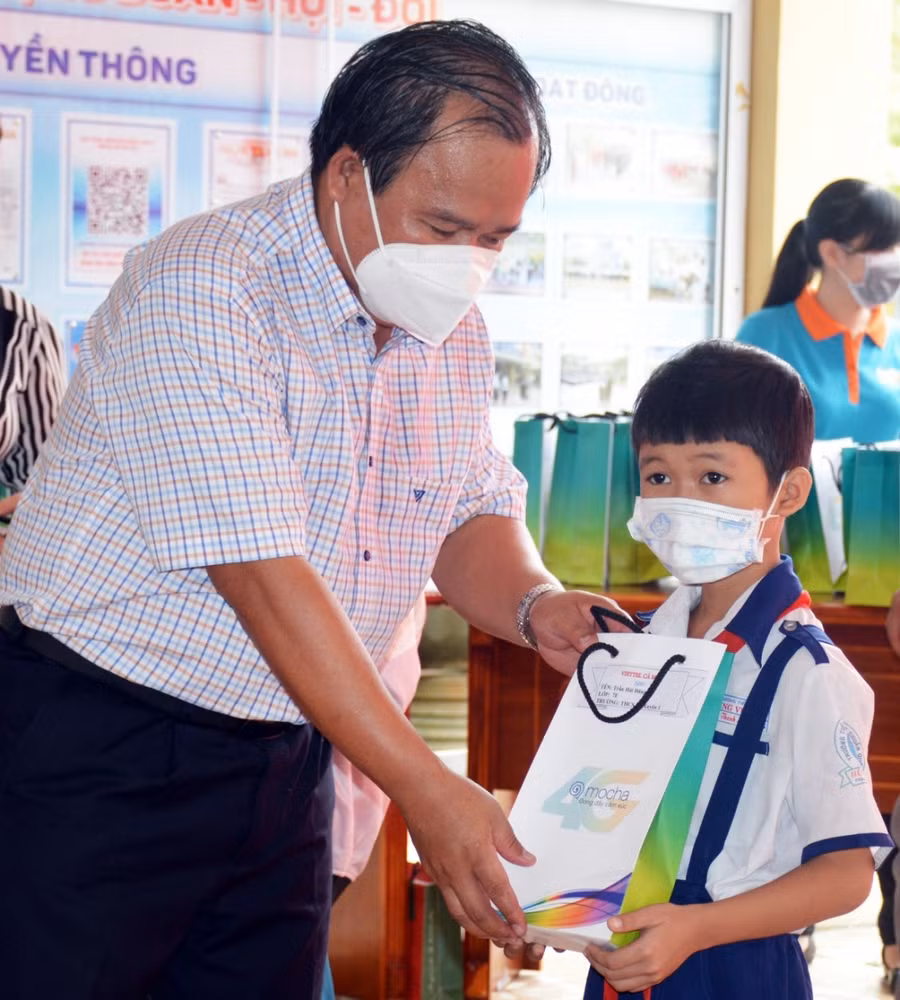 Ông Nguyễn Minh Luân, Giám đốc Sở GD&amp;ĐT Cà Mau trao điện thoại cho các em học sinh hoàn cảnh khó khăn.