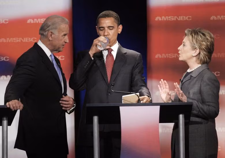 Ứng cử viên tổng thống của đảng Dân chủ, Thượng nghị sĩ Joe Biden (D-DE) nói chuyện với các ứng cử viên khác là Thượng nghị sĩ Barack Obama (D-IL) và Thượng nghị sĩ Hillary Rodham Clinton (D-NY) tại cuộc tranh luận về các ứng cử viên tổng thống của đảng Dân chủ tại Đại học Bang Nam Carolina ở Orangeburg, Nam Carolina, ngày 26 tháng 4 năm 2007. REUTERS/Jim Young.